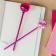 two dsico ball pens in pink placed on a notebook