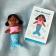 Mini mermaid soft toy placed beside a small illustrated box with mermaid design