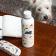 Stainless steel bottle with playful dog illustrations on a table beside a matching glasses case.