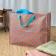 Pink jumbo storage bag with colourful floral designs.