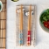 Dog-themed chopsticks set with two ceramic rests in a gift box.
