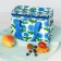 A colourful floral insulated lunch bag displayed beside a drink bottle.