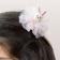  A white bunny‑shaped hair clip with soft decorative details.