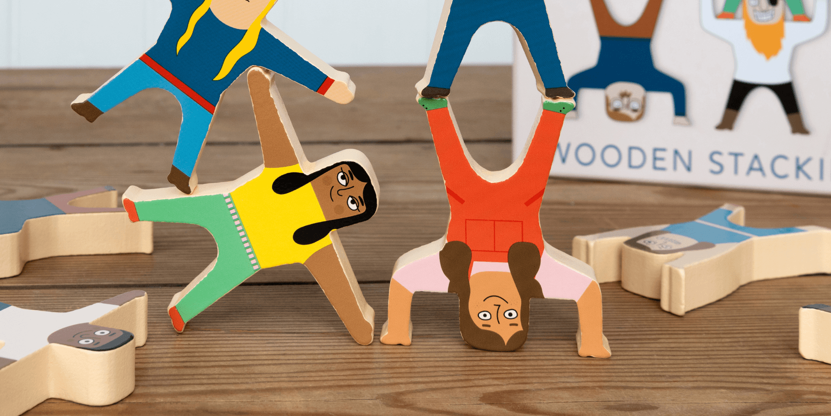 Wooden toy characters are balanced in a tower