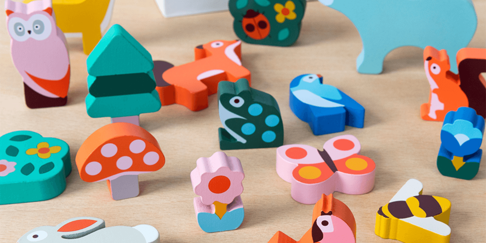 Colourful wooden animals sit on a table