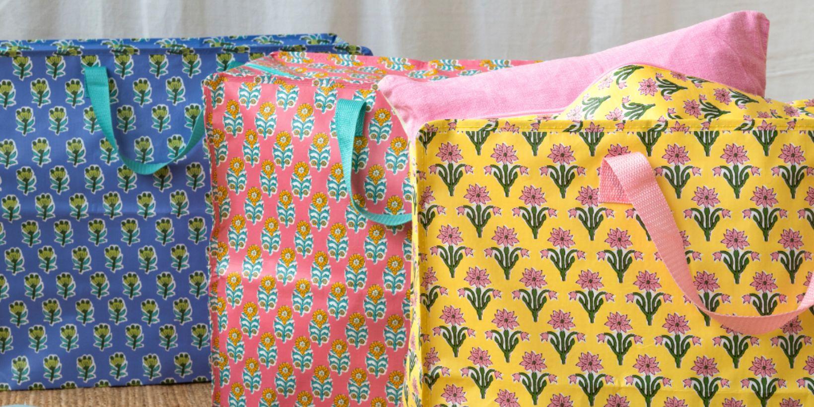 Three large storage bags filled with cushions