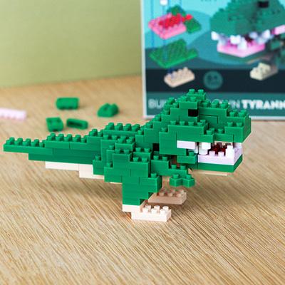 Close-up of a green Tyrannosaurus rex model built from small interlocking plastic bricks.