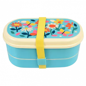 Light blue kids bento box with cream lid and middle tray plus yellow elastic strap featuring print of butterflies amongst flowers