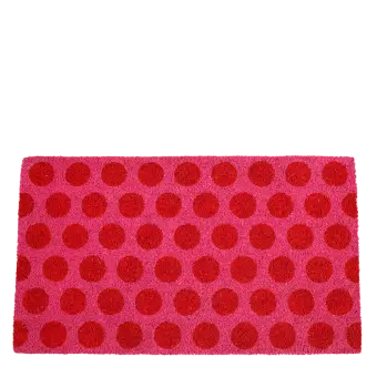 Coir doormat with red spots on pink surface