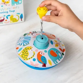 Colourful spinning top toy with a box in the background