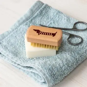 wooden nail brush featuring a sausage dog illustration