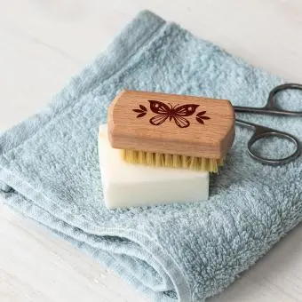 wooden nail brush featuring a butterfly illustration