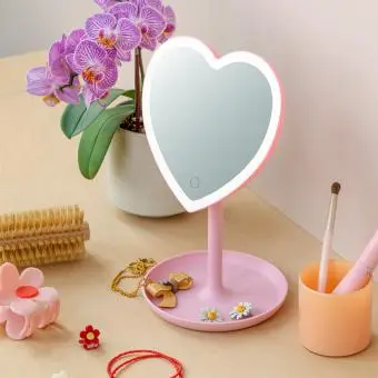 Heart-shaped LED vanity mirror on a stand with accessories