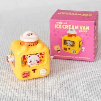yellow wind up ice cream van with pink packaging box in background