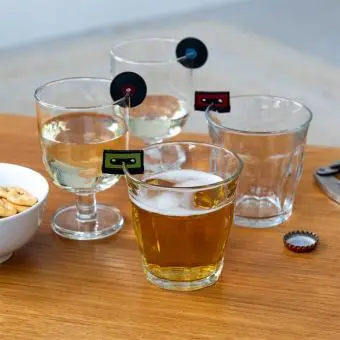 vinyl records and cassette tapes drink markers attached to glasses