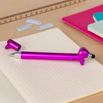 Pink sausage dog stylus ballpoint pen with cap off, lying on a notebook