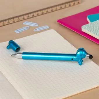 blue sausage dog stylus ballpoint pen with cap off, lying on a notebook