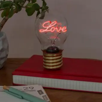 Love usb light bulb placed on a book with light on