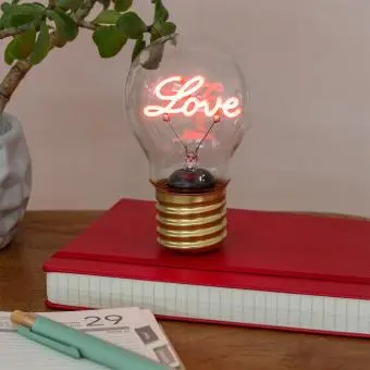 Love usb light bulb placed on a book with light on