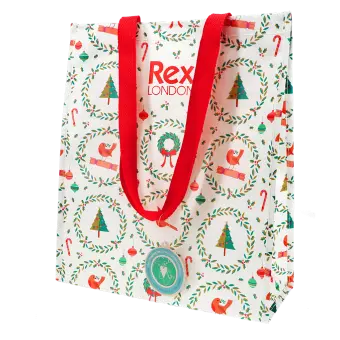 Festive Christmas design shopping bag with red handles and a tag 