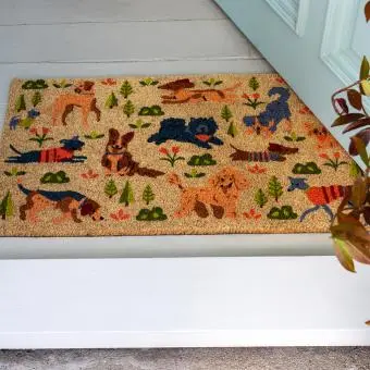Colourful doormat featuring various dogs in different poses and colours