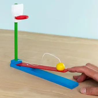 wooden tabletop basketball game with a yellow ball