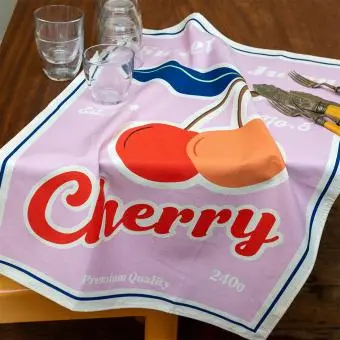 Cotton tea towel featuring a cherry print with pink background