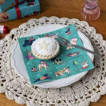 festive friends napkins feature illustrations of different dogs in winter clothing