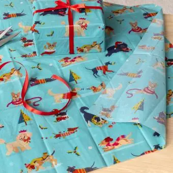 festive friends tissue paper feature illustrations of dogs in winter clothing 