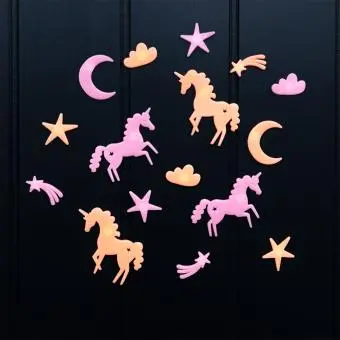 Assorted glow-in-the-dark unicorn featuring stars, moons, and clouds on a black background