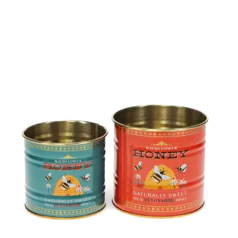 Two storage tins, one small and one large, featuring bees, flowers, and beehive illustrations.