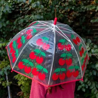 Transparent umbrella with red trim and cherry pattern
