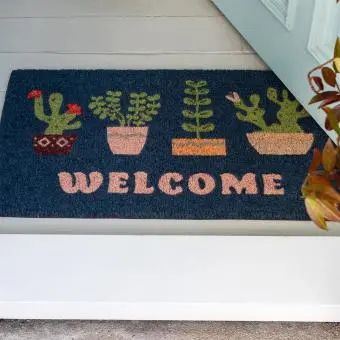 Colourful doormat featuring different pot of plant and welcome letter print