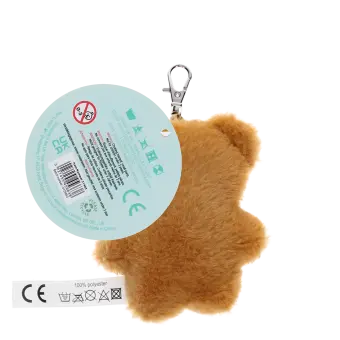 Light brown plush teddy bear keychain with a red polka-dotted bandana, metal clasp for attachment, and a tag with safety warnings