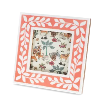 Square pink picture frame with white leaf patterns on the border.