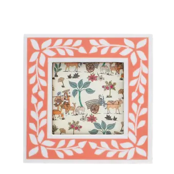 Square pink picture frame with white leaf patterns on the border.