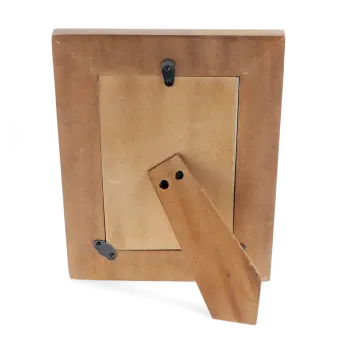 back view of a picture frame with black metal clips and a stand