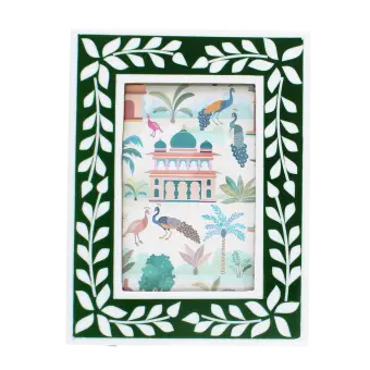 picture frame with a green border and white leaf patterns