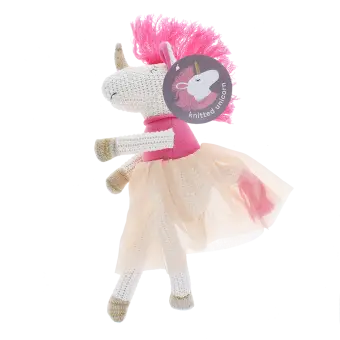 Knitted unicorn toy wearing a pink top and skirt with tag