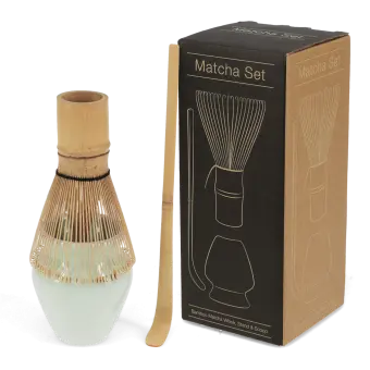 Matcha set with bamboo whisk, ceramic whisk holder, and scoop, displayed beside a labelled box 