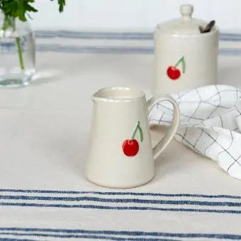 Stoneware milk jug featuring cherry print with handle 