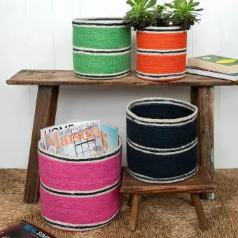 Four woven storage baskets in varying sizes and colours