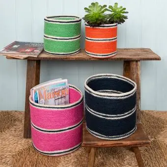 Four woven storage baskets in varying sizes and colours