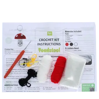 Crochet kit with yarns, hook, needle, stuffing, and instructions to make toadstool keyring