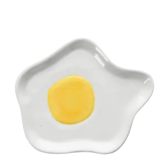 White ceramic trinket dish shaped like a fried egg with yellow yolk design