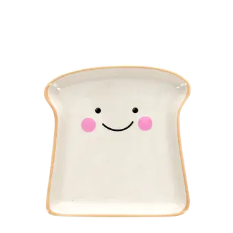 Ceramic trinket dish shaped like a slice of bread with a smiling face and pink cheeks