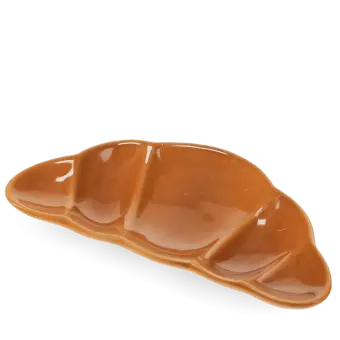 Brown ceramic trinket dish shaped like a croissant.