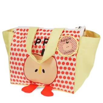 Yellow handbag with red polka dots and a cartoon apple design with two red feet at the bottom with tag