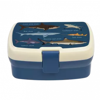 Dark blue lunch box with cream and dark blue lid featuring images of sharks