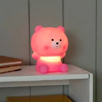 Pink teddy bear night light with light on